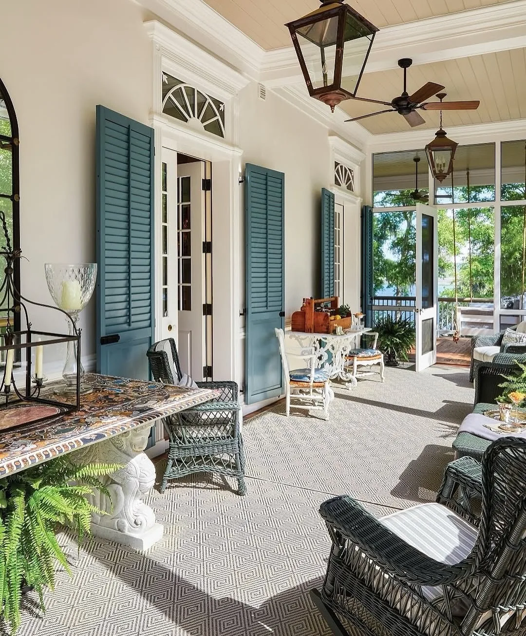 Covered porch with blue shutters echoing the entry color