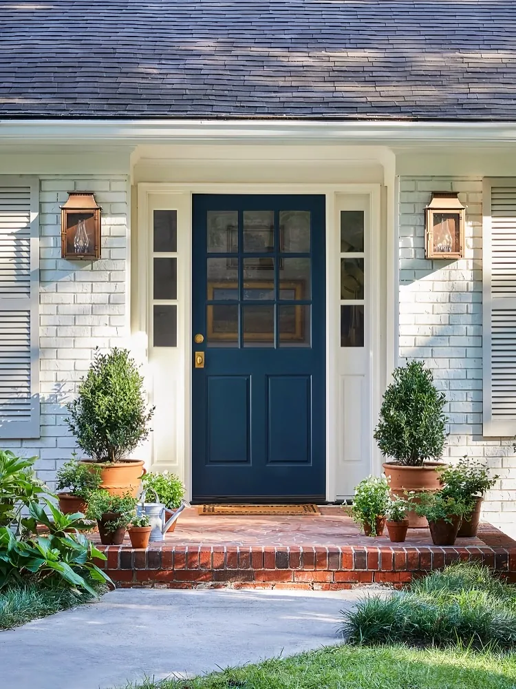 Navy blue front door with strong curb appeal against pale siding