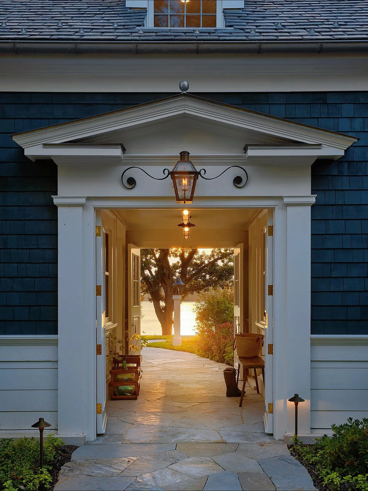 Navy shingle breezeway with a pediment and lantern over the entry