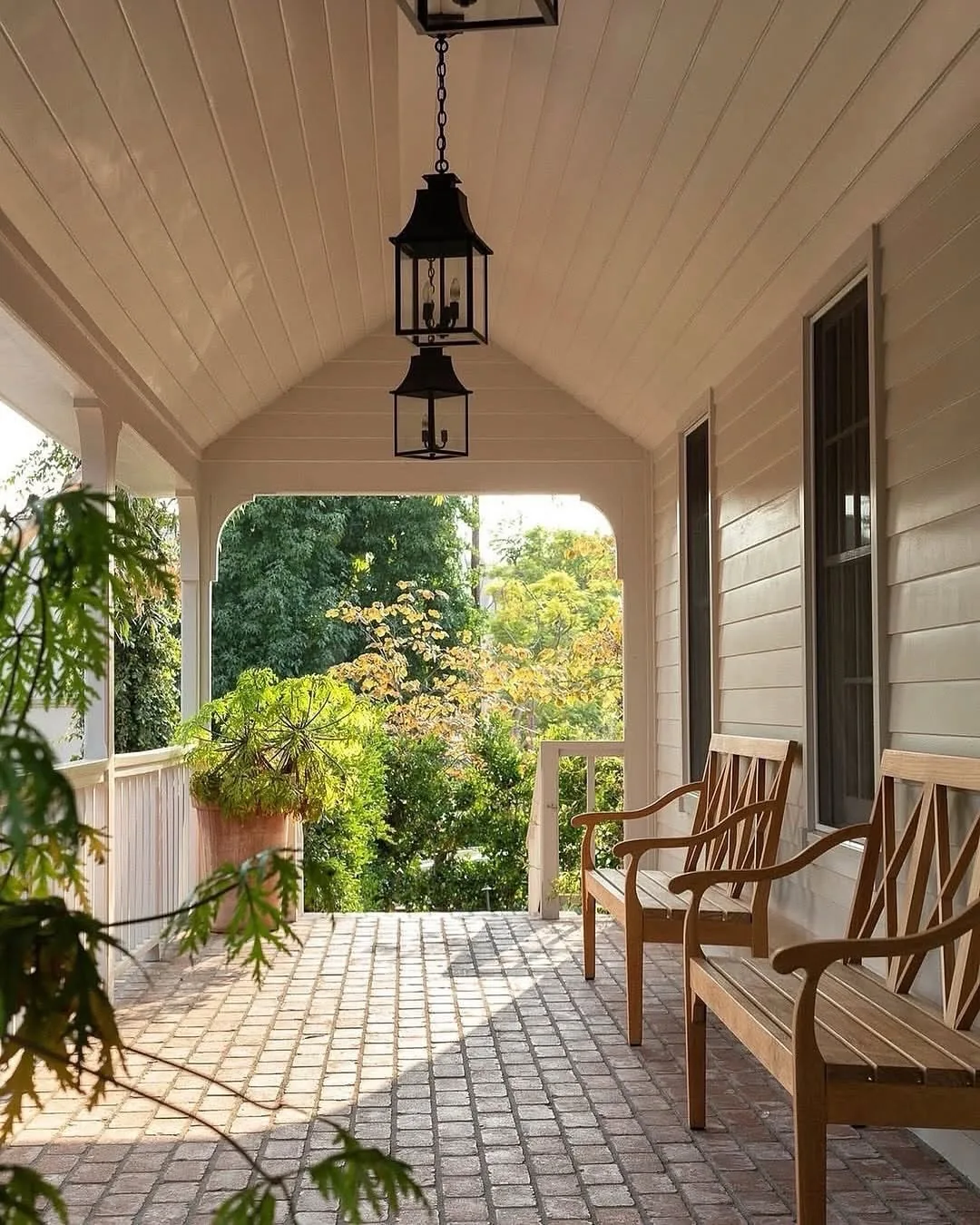 Covered front porch with a brick floor