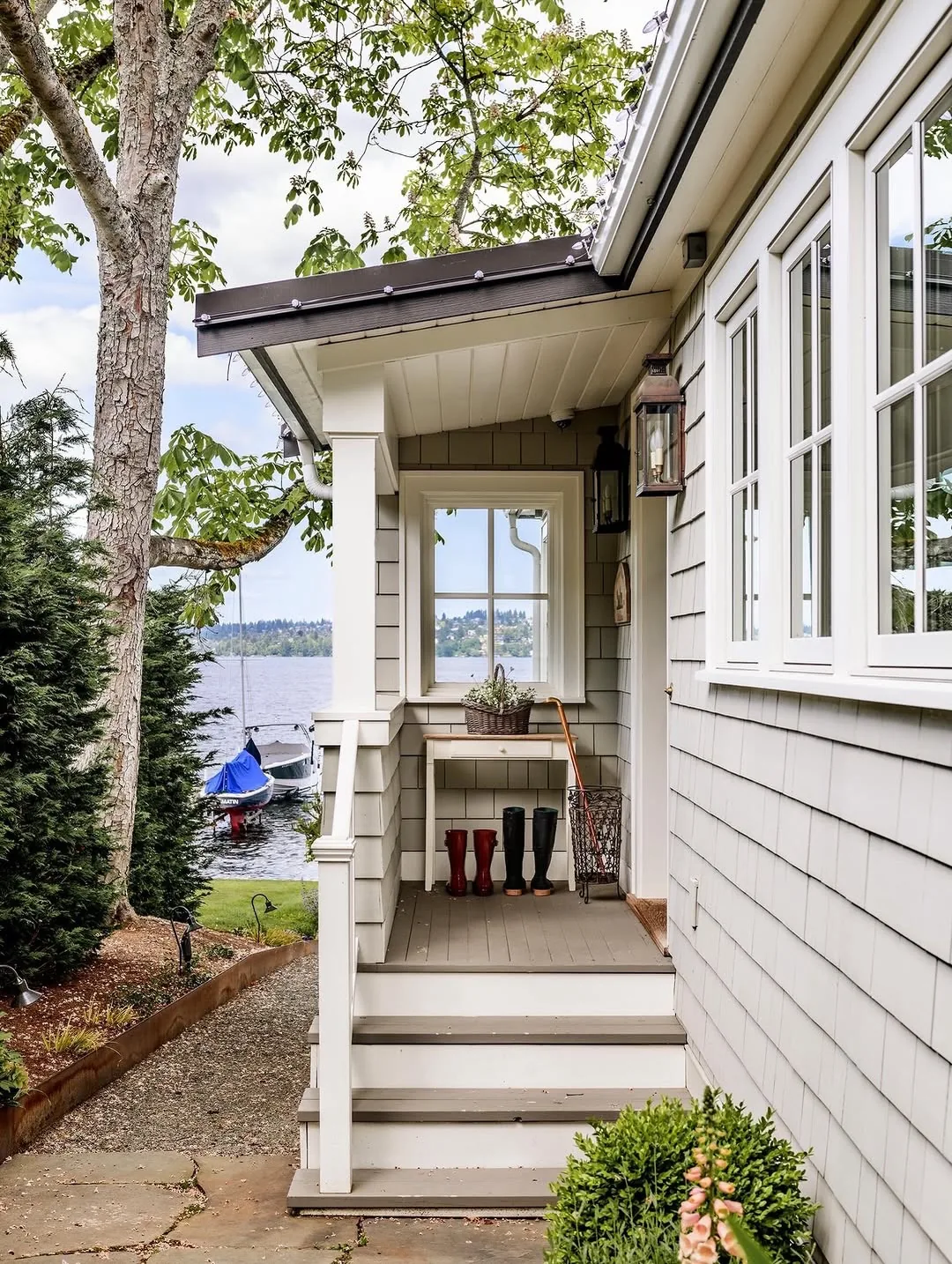 Lake house shingle side porch with steps leading down