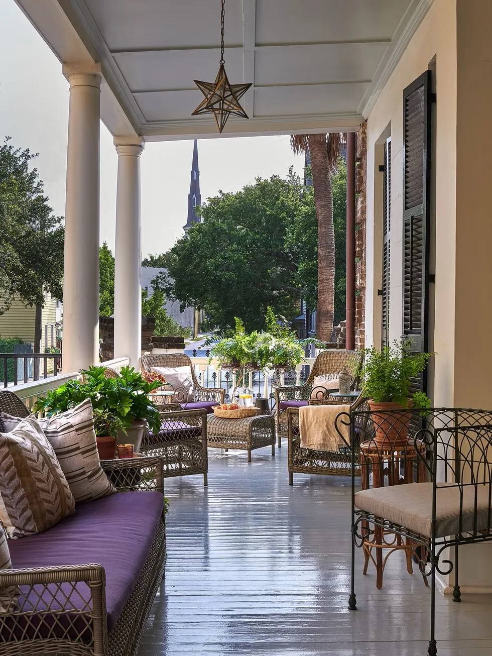 Charleston piazza with white columns and wicker seating