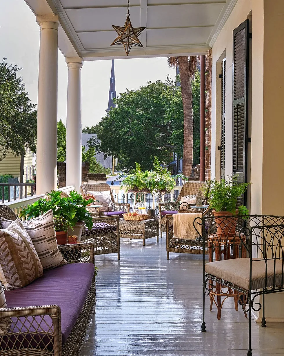 Columned porch with wicker seating, purple cushions and a star detail