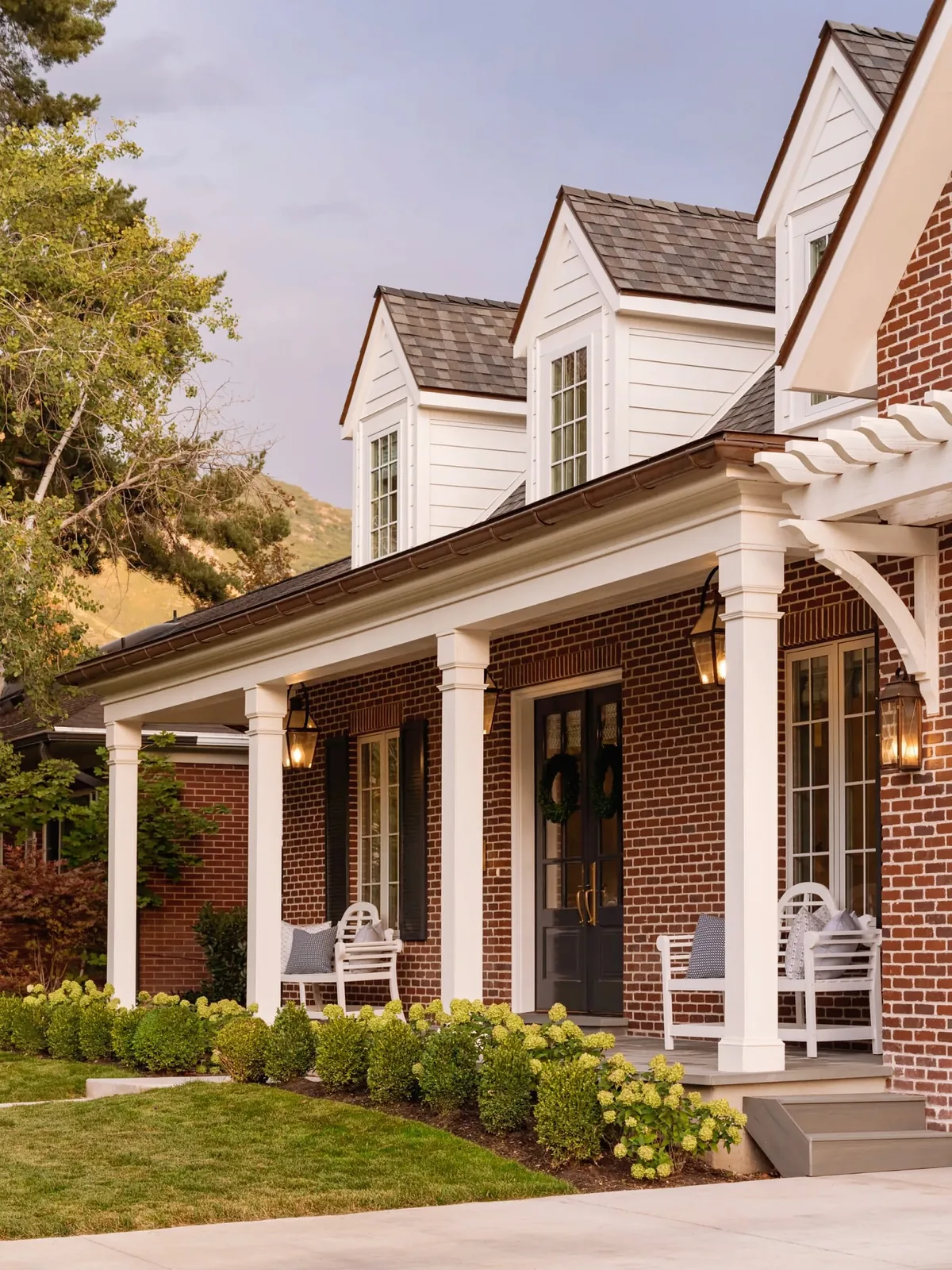 Red brick ranch with a white column porch across the front