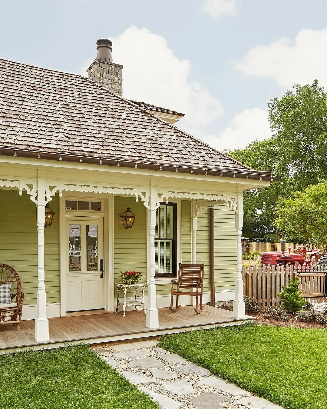 Sage green cottage front porch with a green door