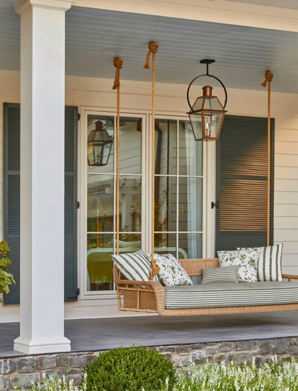 Front porch rope hanging swing bed swaying under the beams