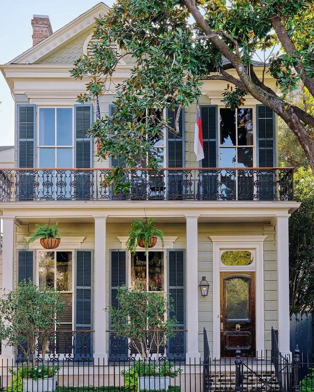 New Orleans house with an iron balcony and blue shutters
