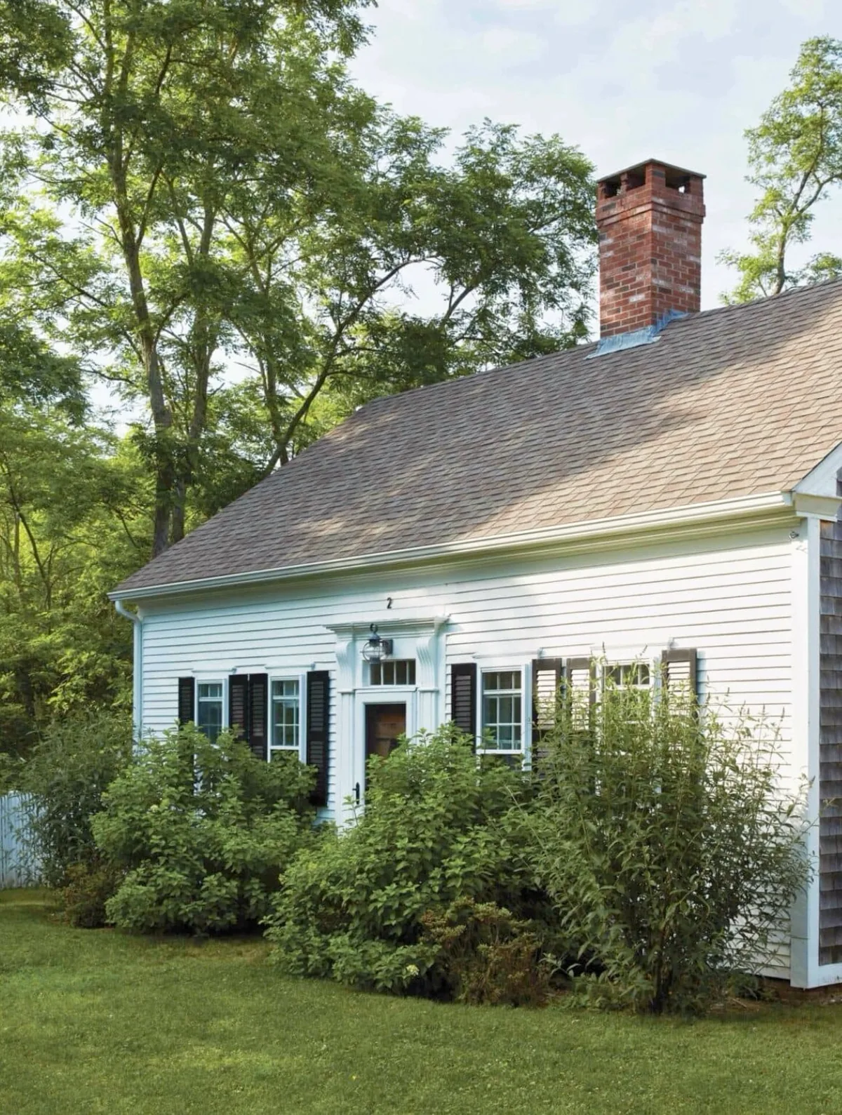White Cape Cod house with black shutters