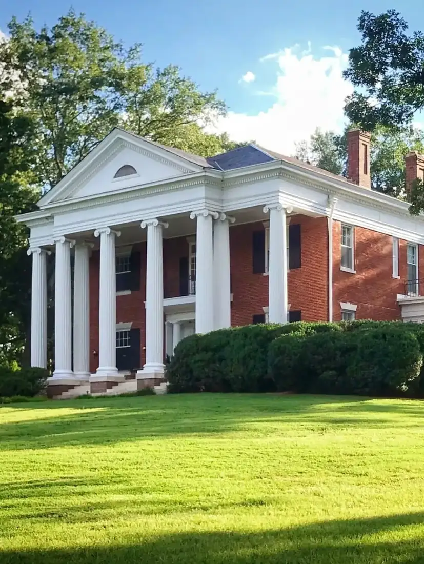 Red brick Greek Revival house with tall white columns across the front