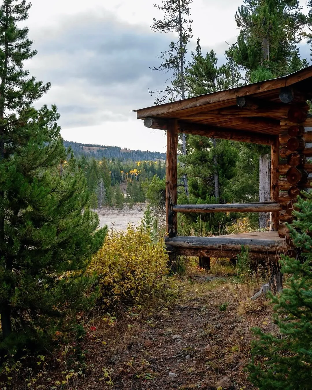 Rustic log cabin with a covered porch in the mountains
