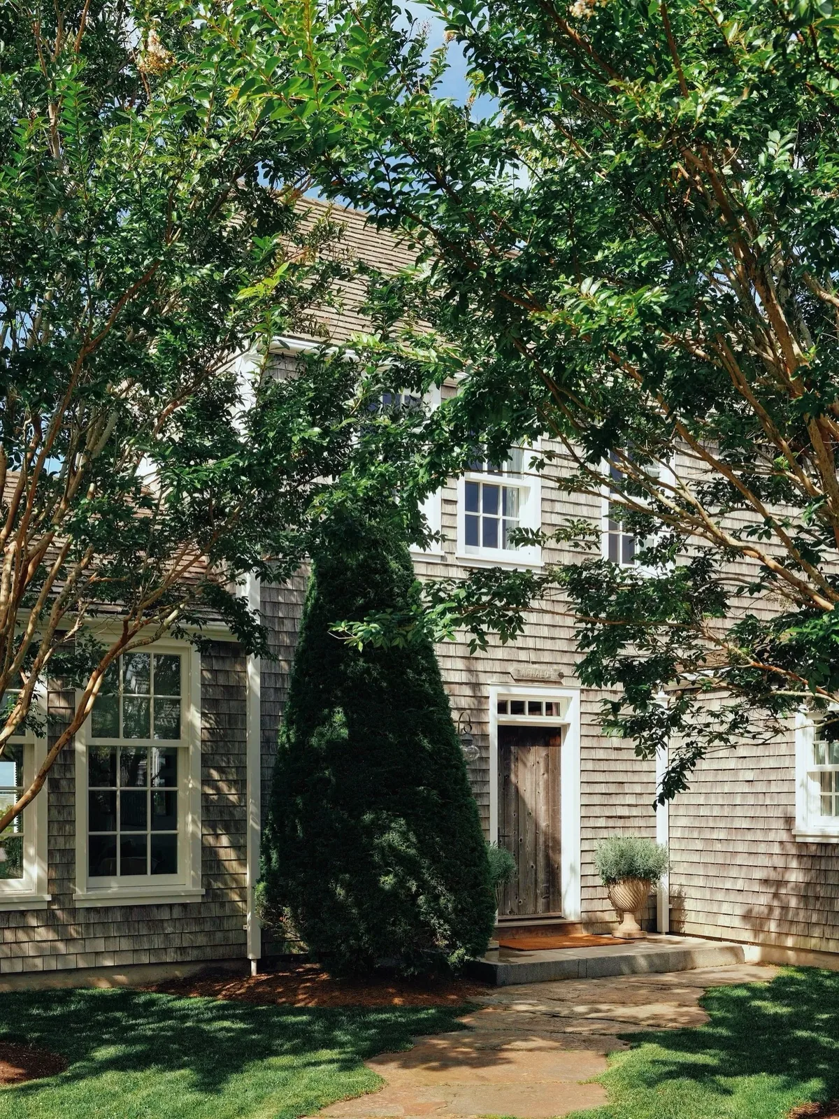 Weathered shingle cottage with crepe myrtle in bloom