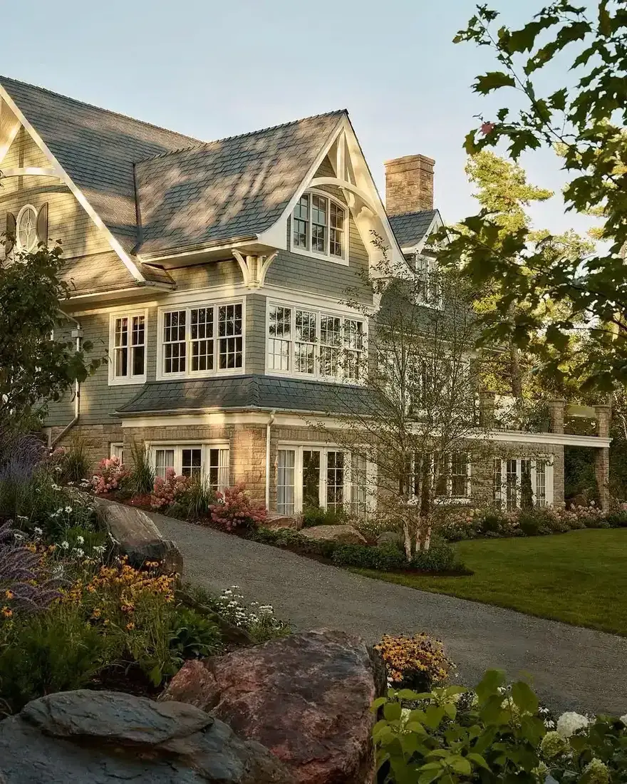 Grey cedar shingle house with white trim and symmetrical gables