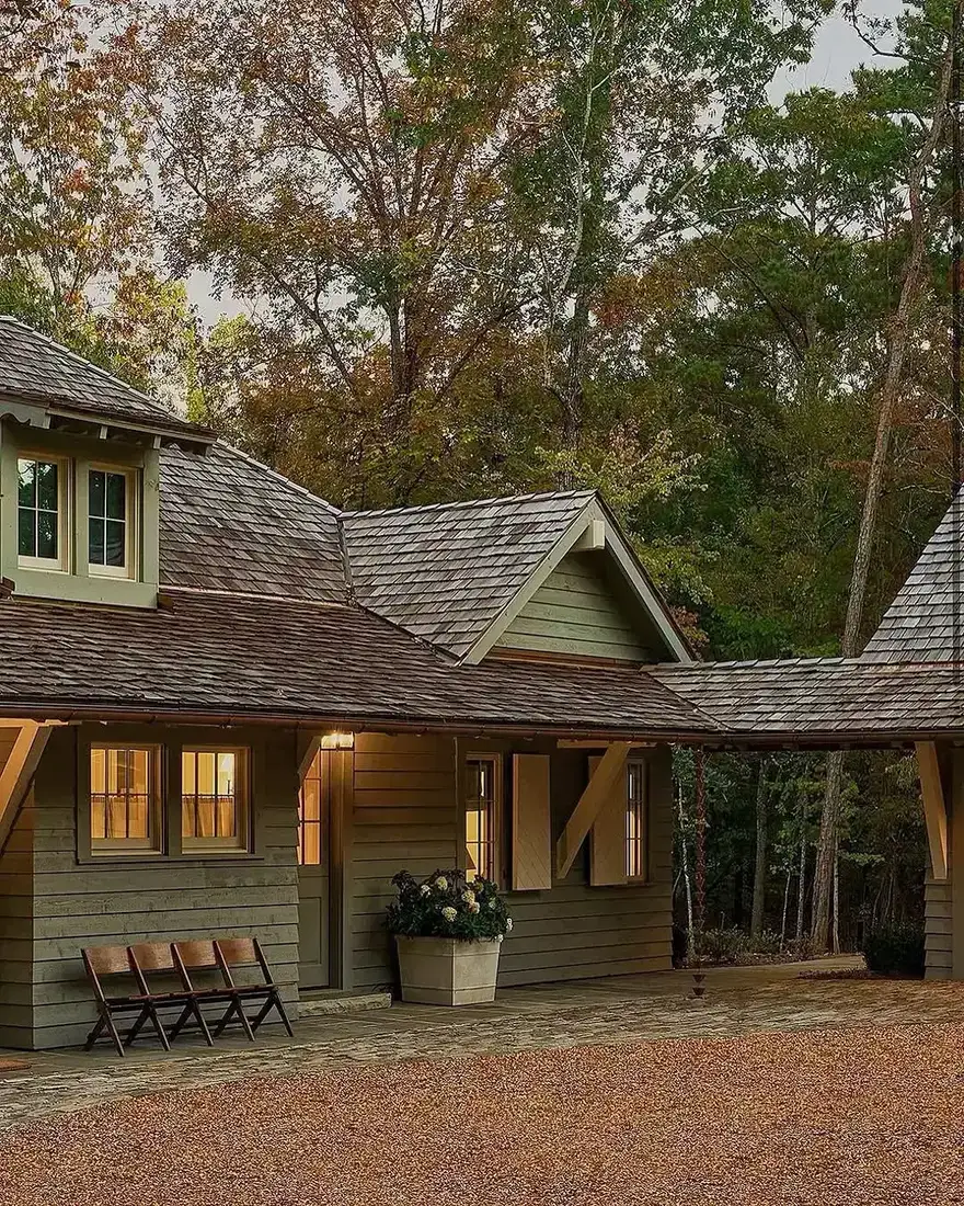 Sage green shingle cottage with breezeway connecting to carport