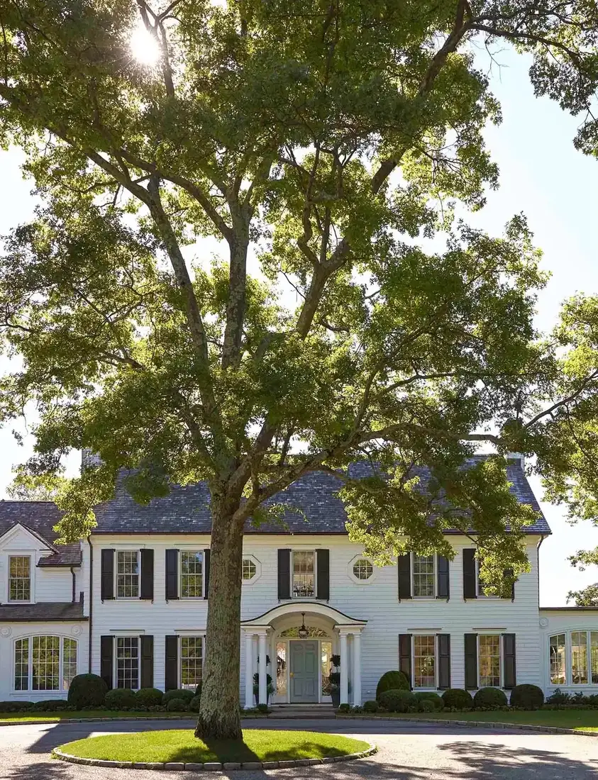 White colonial house exterior with strong curb appeal and manicured landscaping