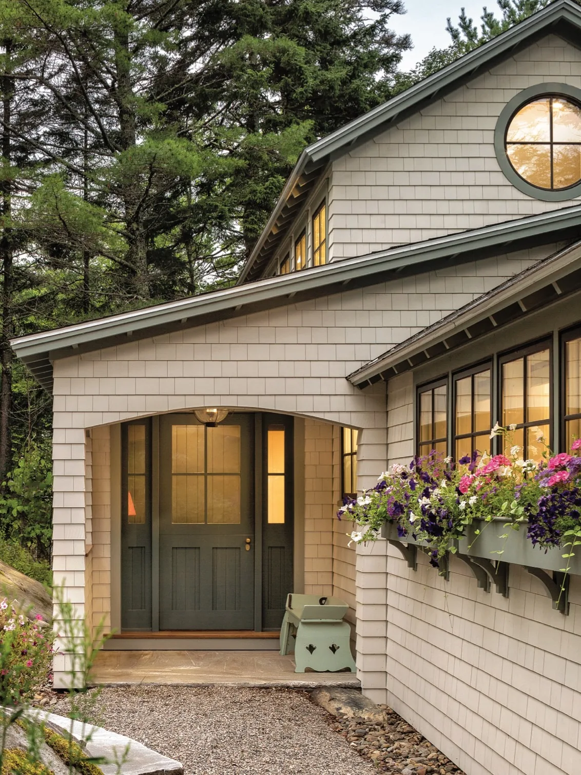 Sage green front door on a cottage exterior