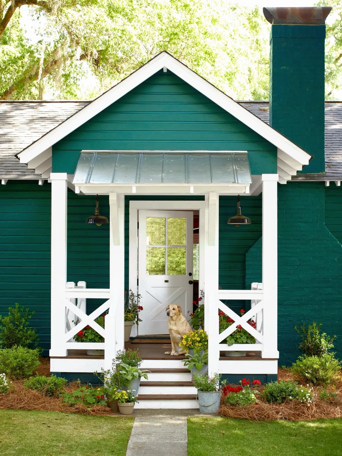 Teal cottage with white porch columns