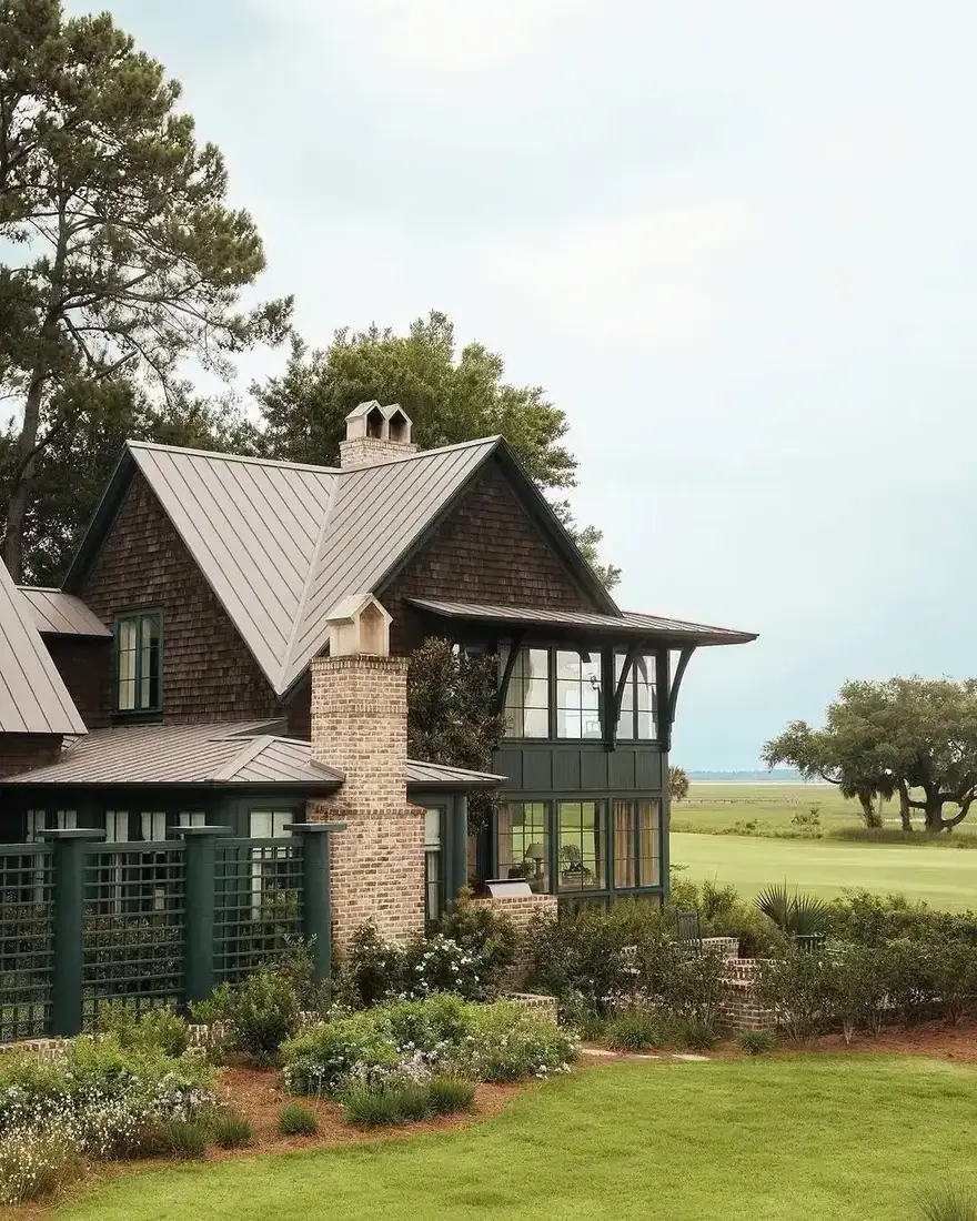 Dark shingle cottage exterior with white trimmed windows and gabled roof
