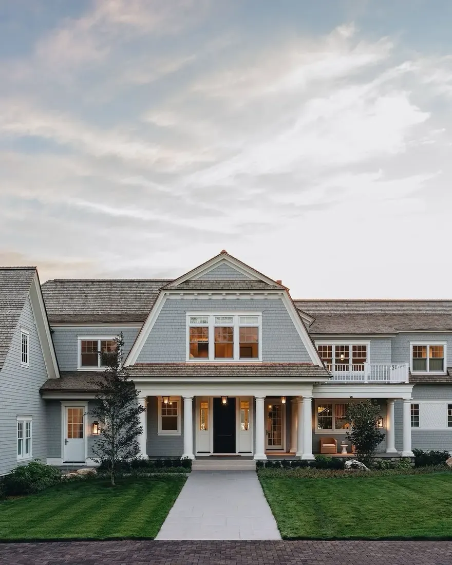 Grey shingle gambrel house with lawn path leading to the front porch
