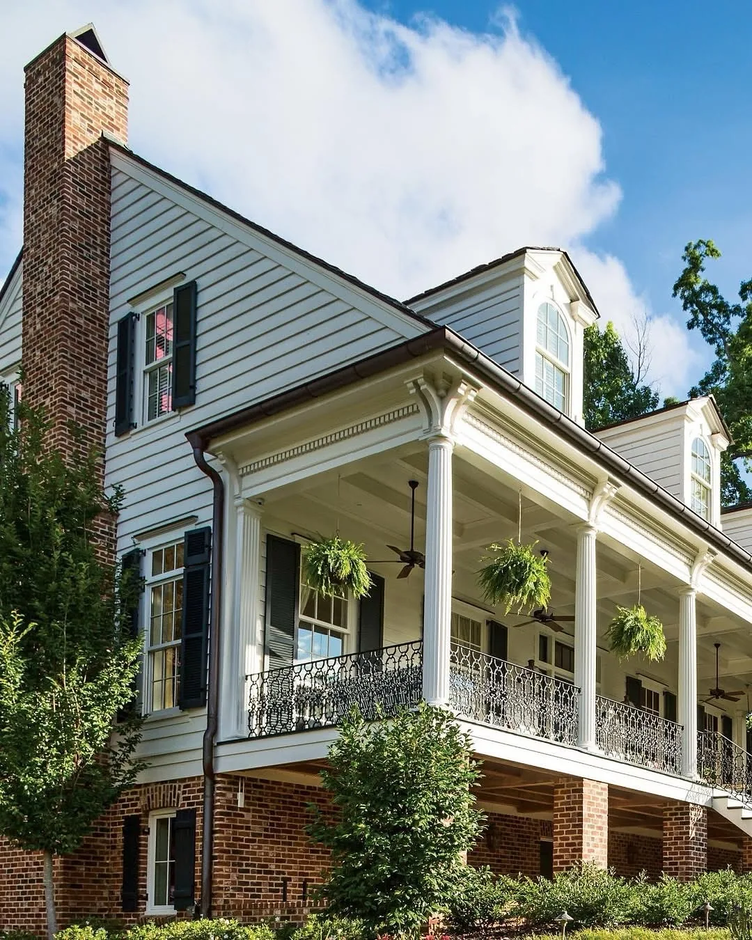 Greek Revival house with a double porch and iron railing