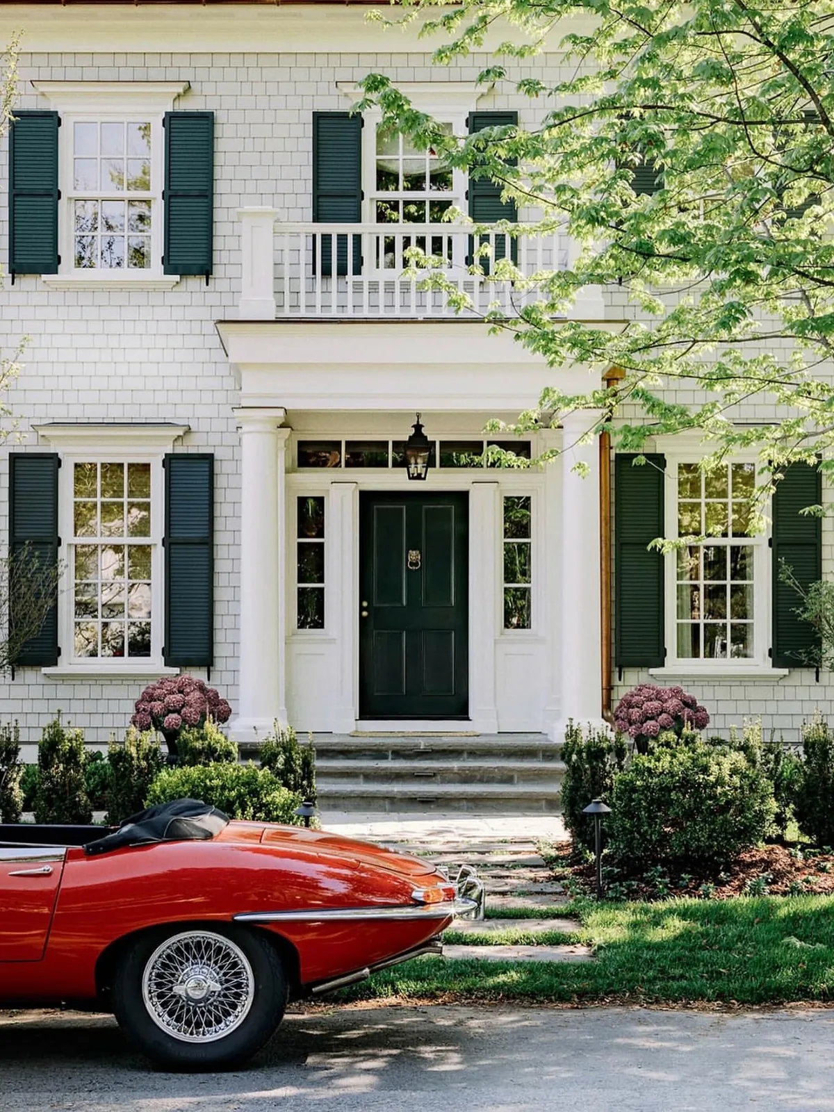 White clapboard Greek Revival house with green shutters