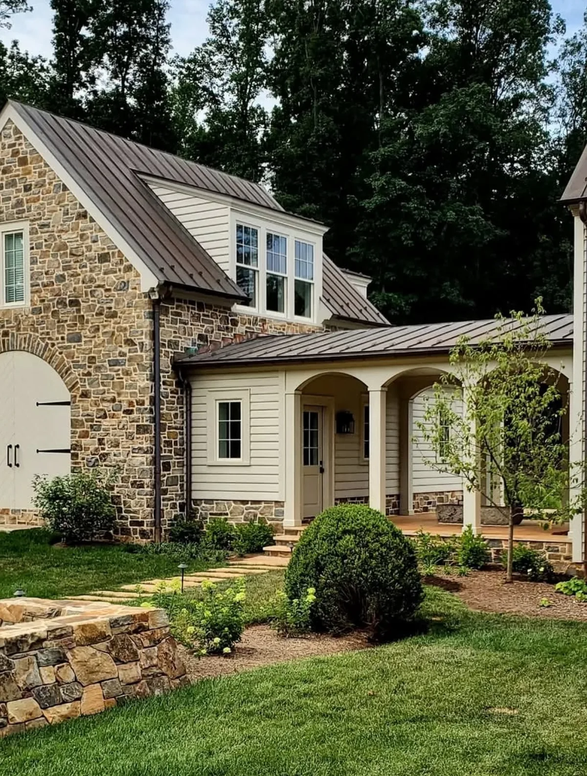 Stone cottage with a standing seam metal roof