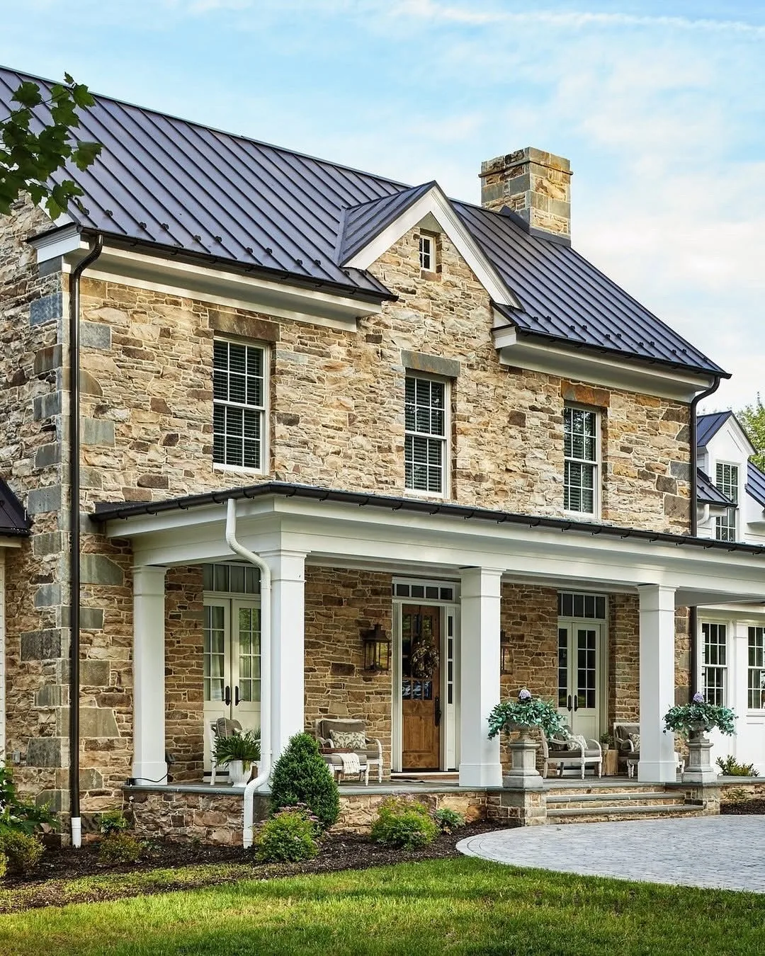Stone farmhouse with a dark metal roof