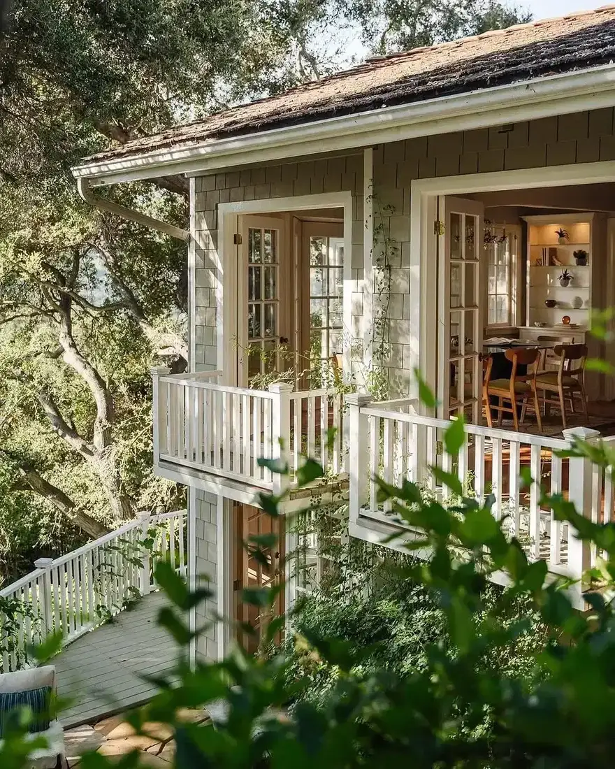 Shingle cottage with double porch and balcony with white columns