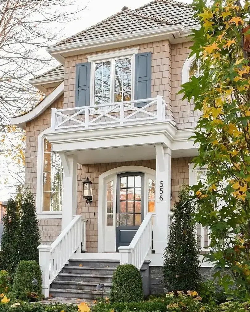 Large shingle style home exterior with symmetrical gables and lawn