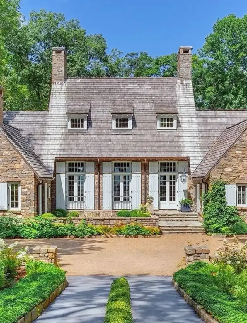 Stone French cottage with slate roof and soft sage shutters