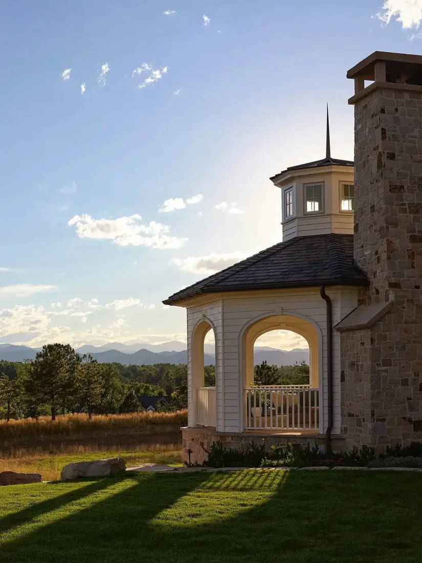Stone house with cupola turret and mountain view beyond