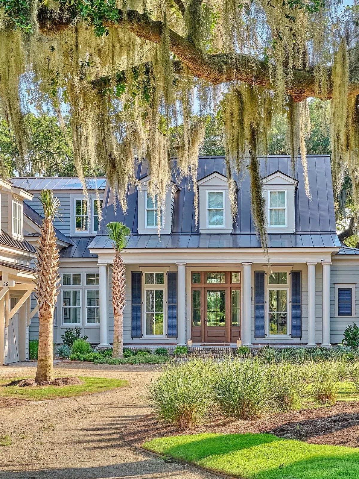 Blue coastal stucco house with palms and Spanish moss