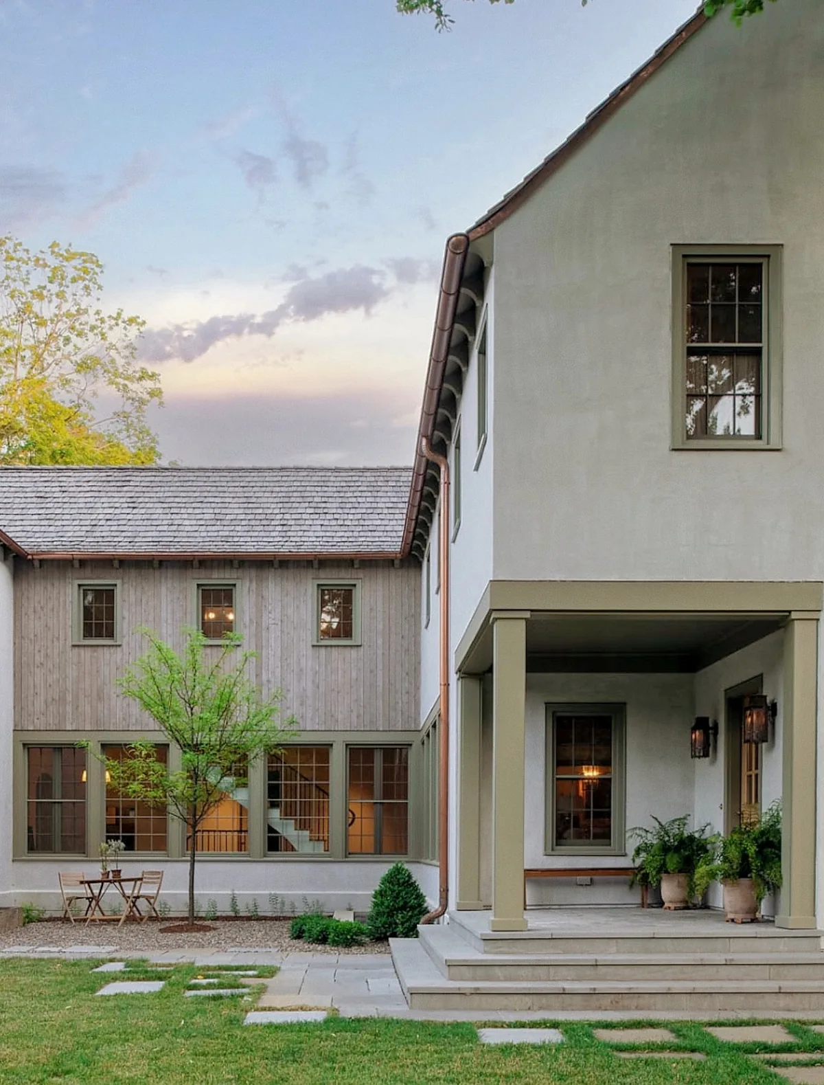 Pale stucco modern farmhouse with a covered porch
