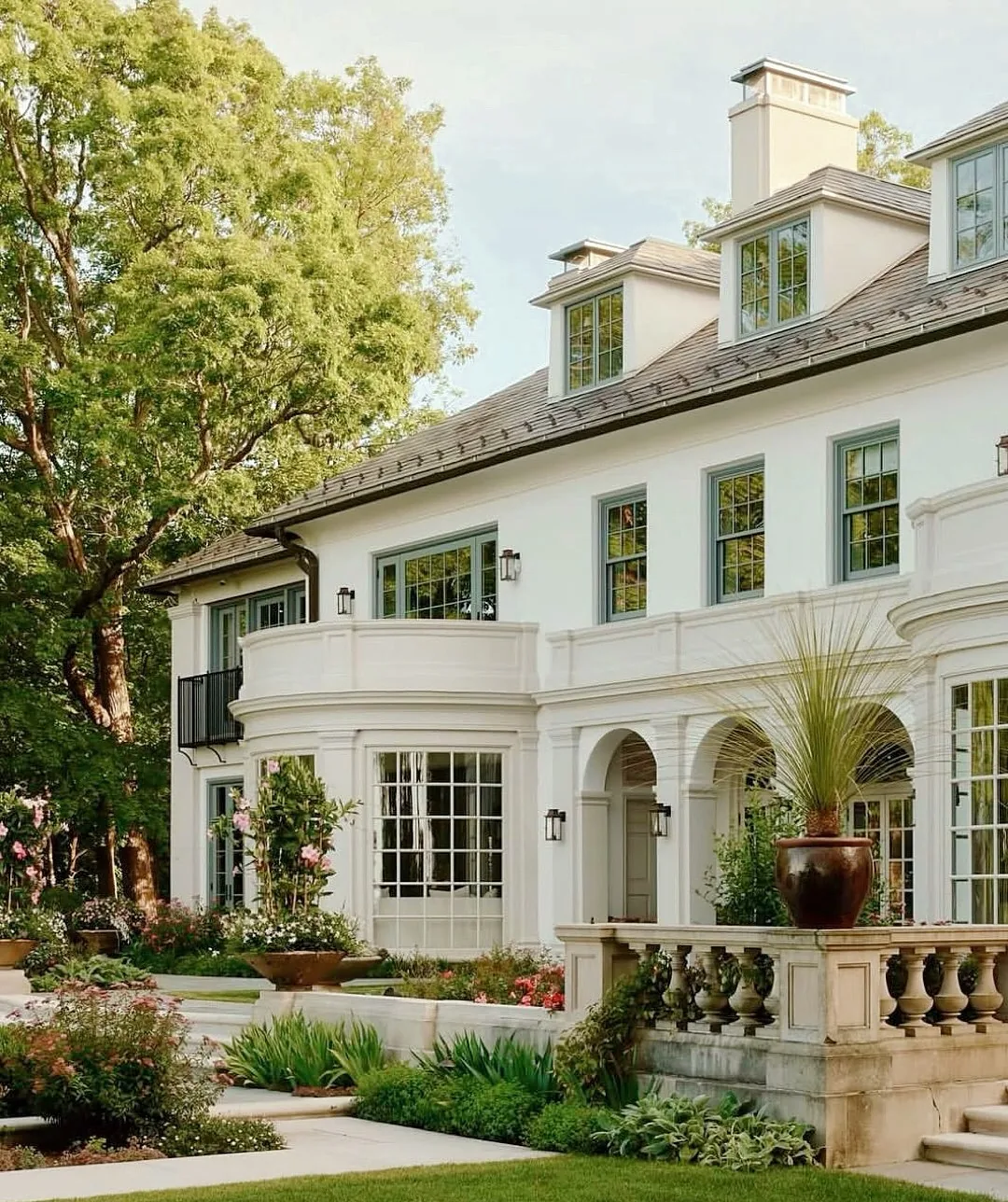 White stucco arcade with a balustrade over a terrace garden