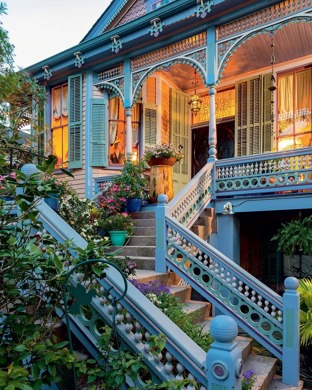 Blue Victorian cottage with gingerbread porch and stairs