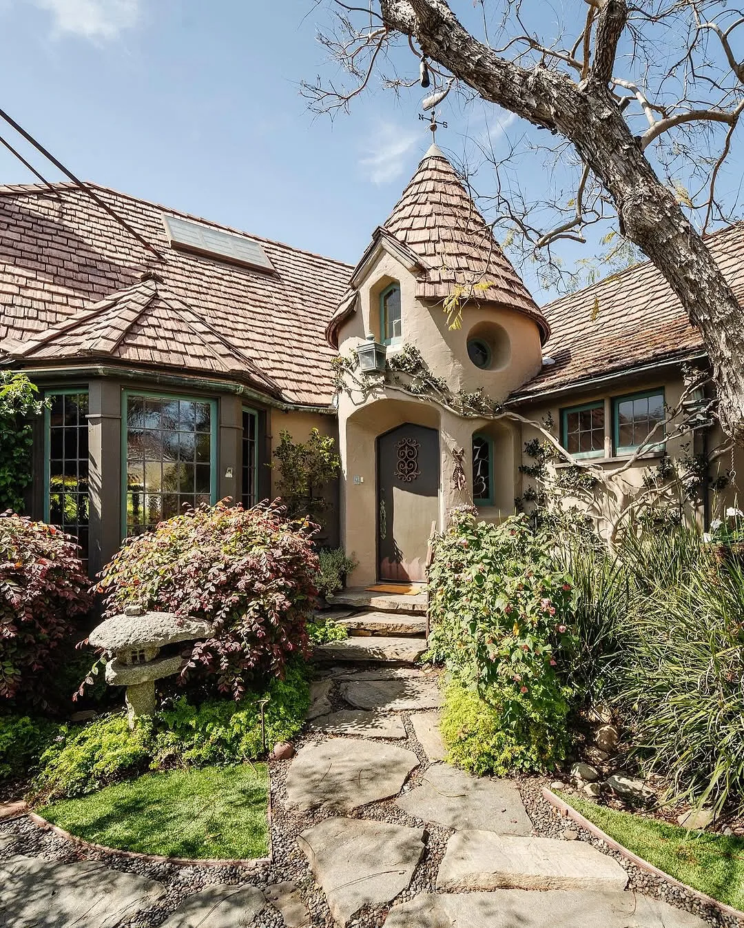 Storybook stucco cottage with a turret and garden path