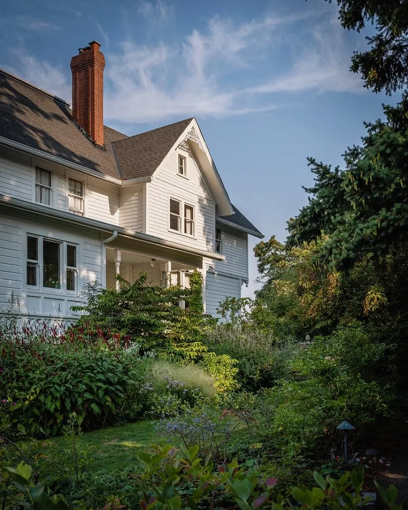 White Victorian house with a cottage garden