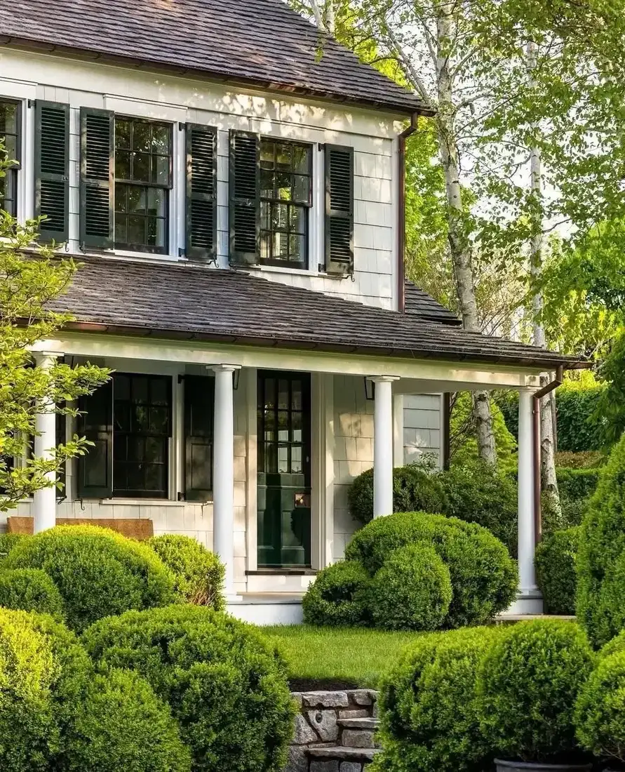 White farmhouse exterior curb appeal with metal roof