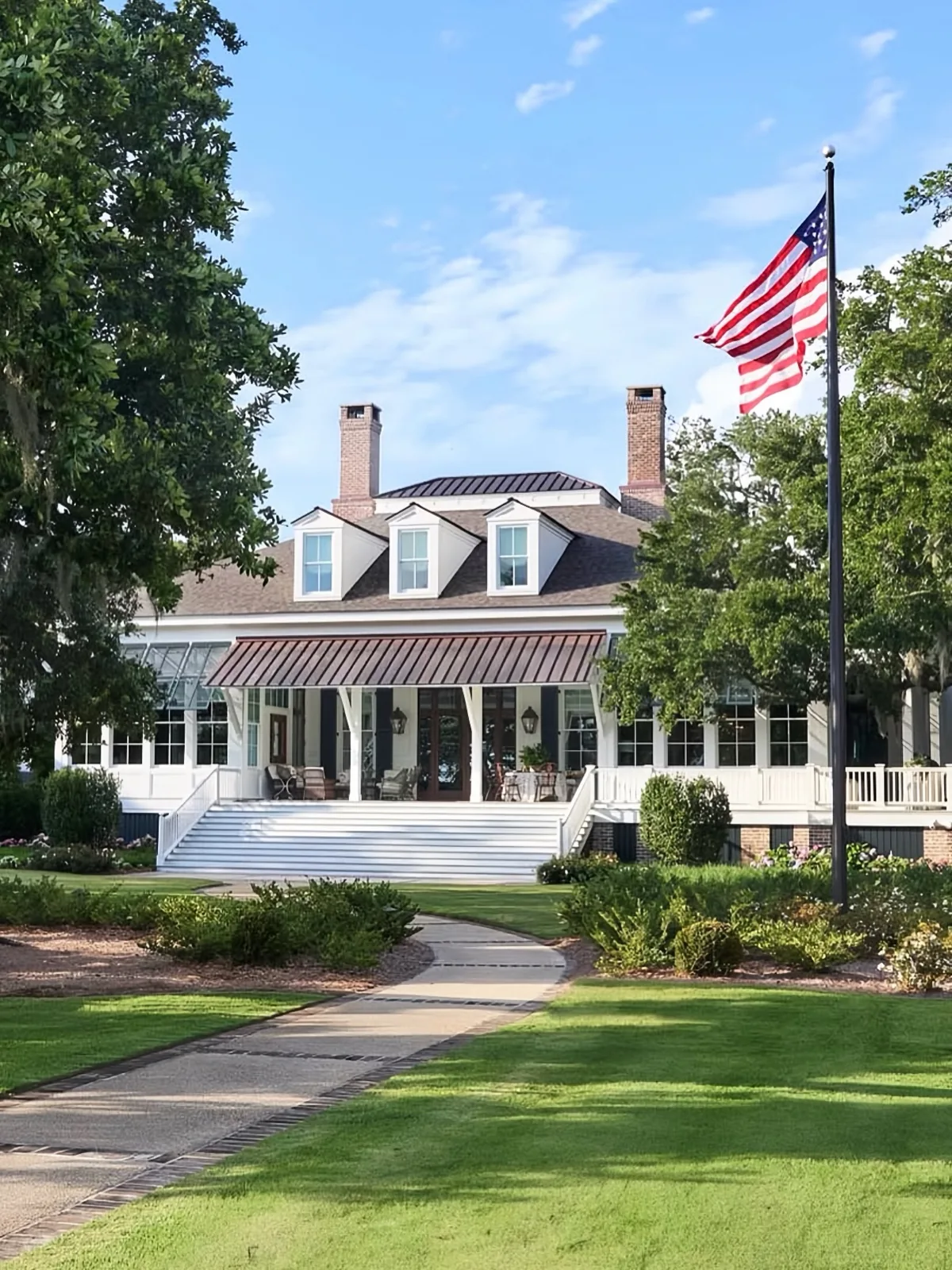 White house exterior with curb appeal and layered planting