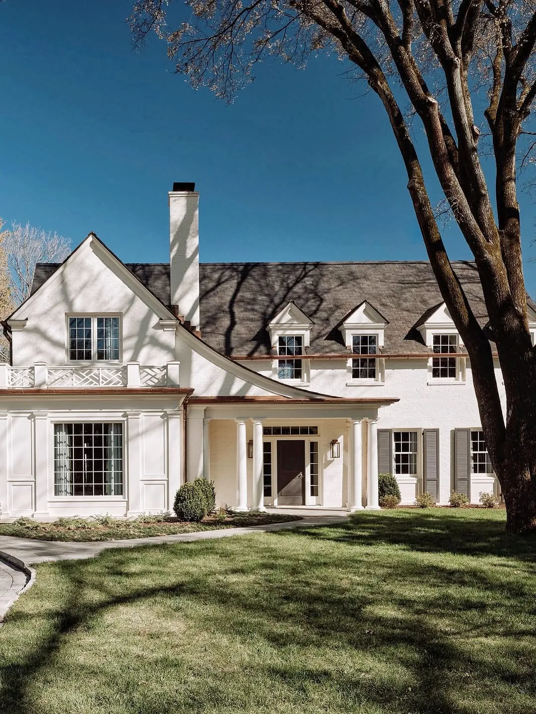 White house exterior with curb appeal and a straight walk