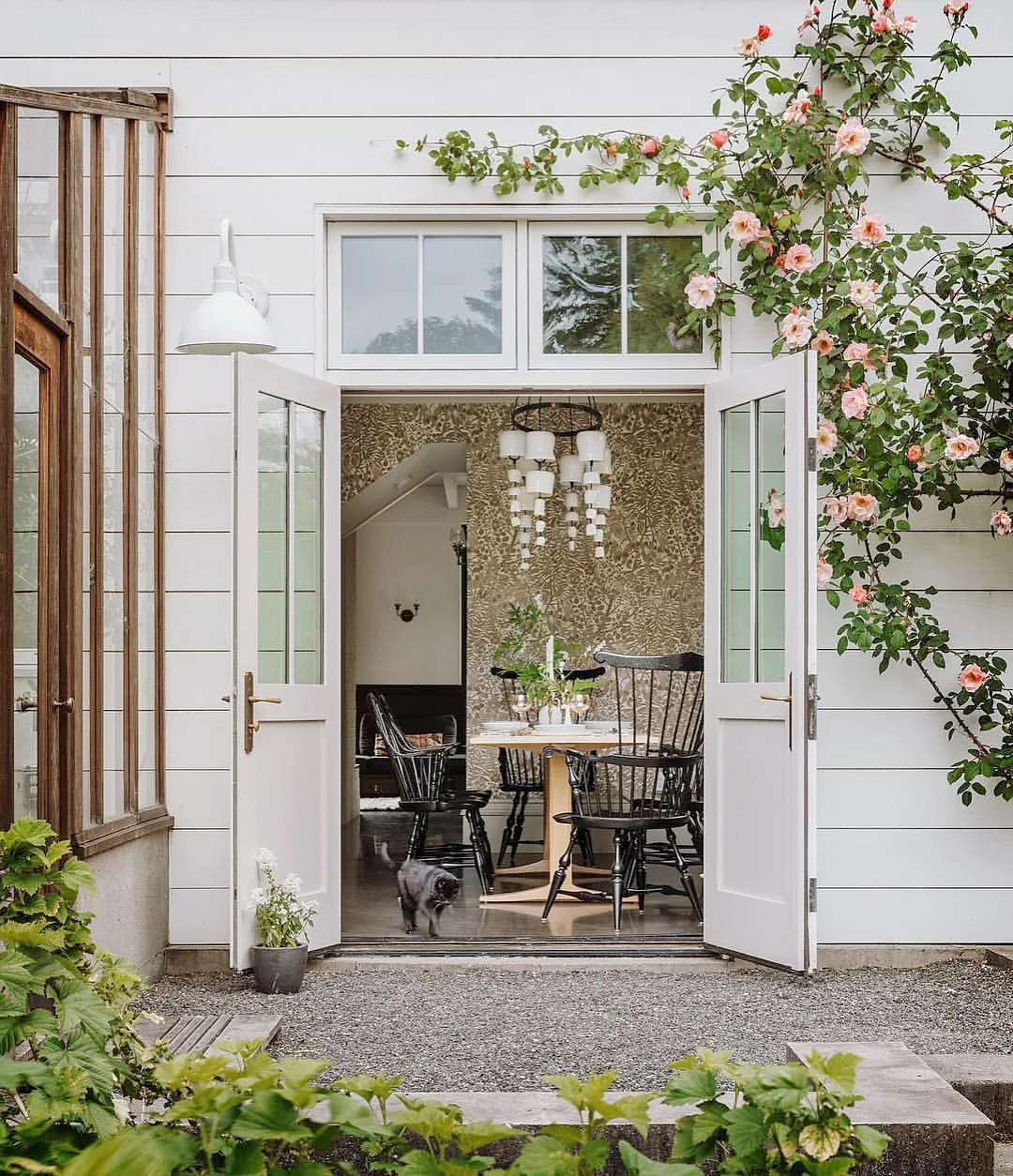 White house with French doors and climbing roses