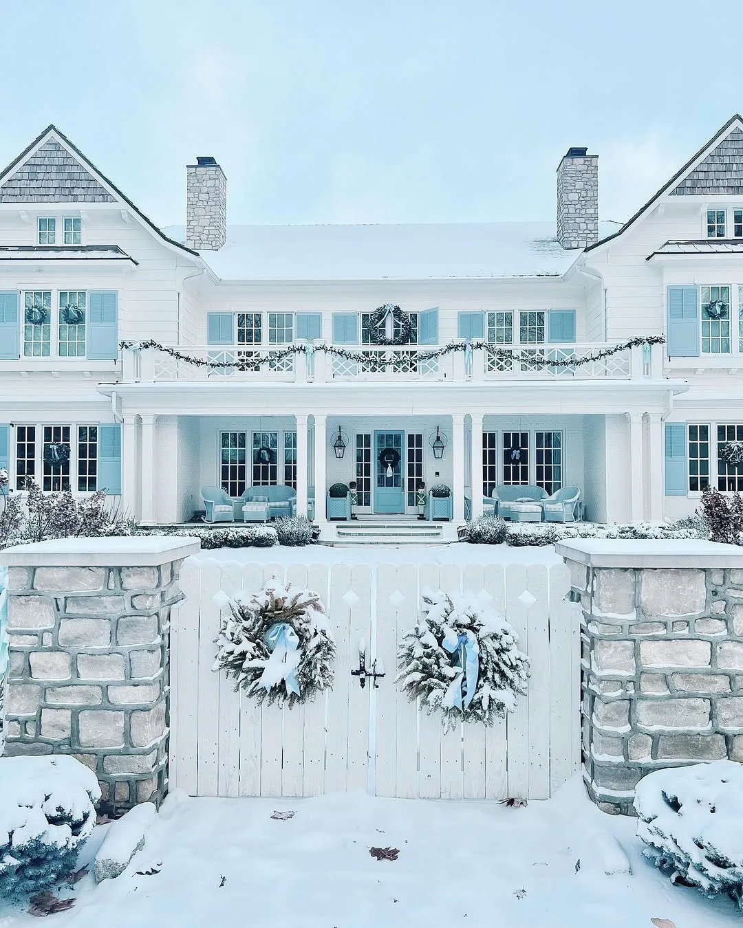 White house in snow with Christmas wreaths