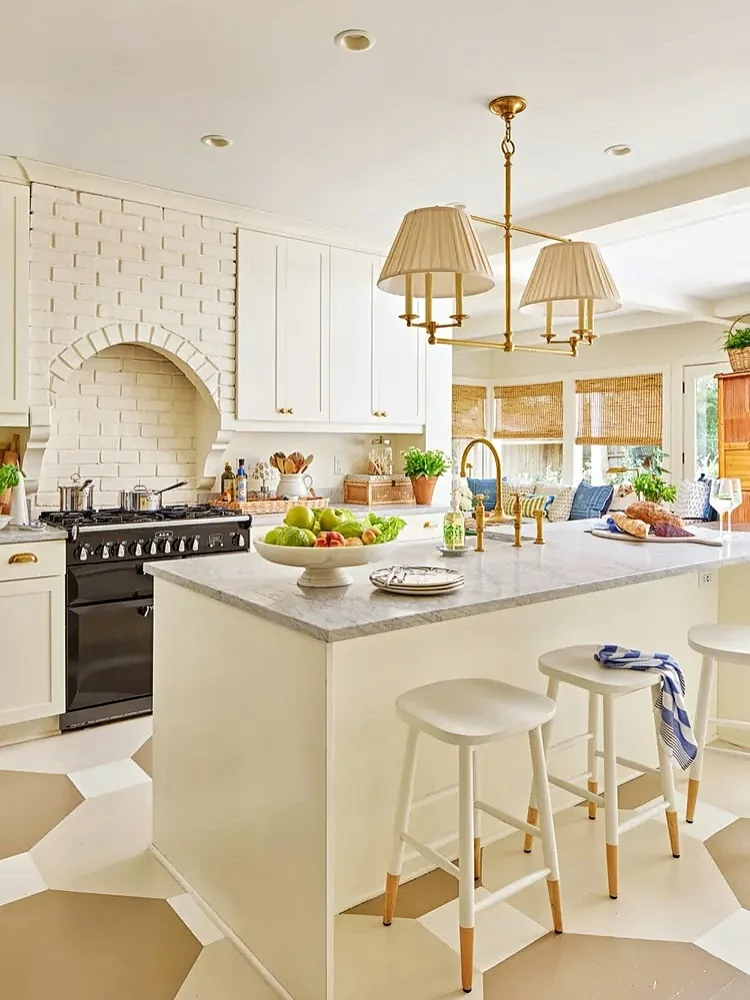 White kitchen with a brick arch range hood