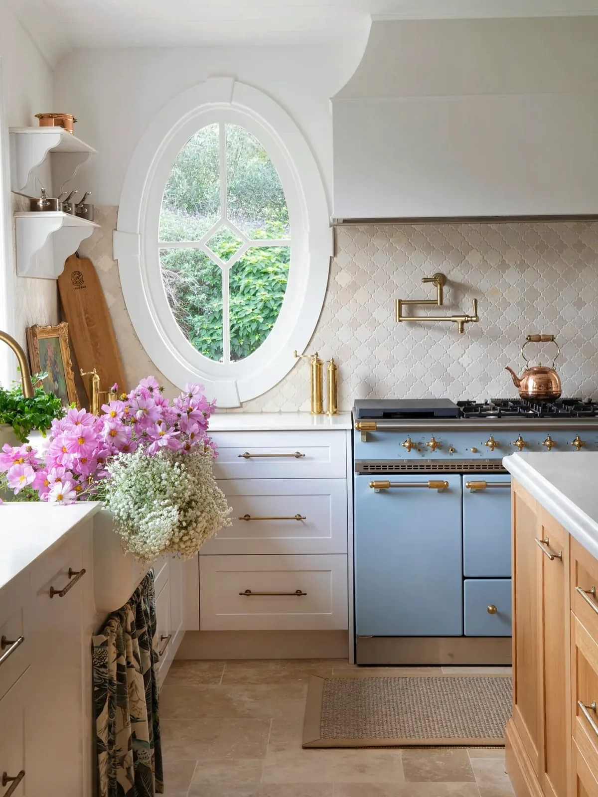 Blue French country kitchen with detailed cabinetry