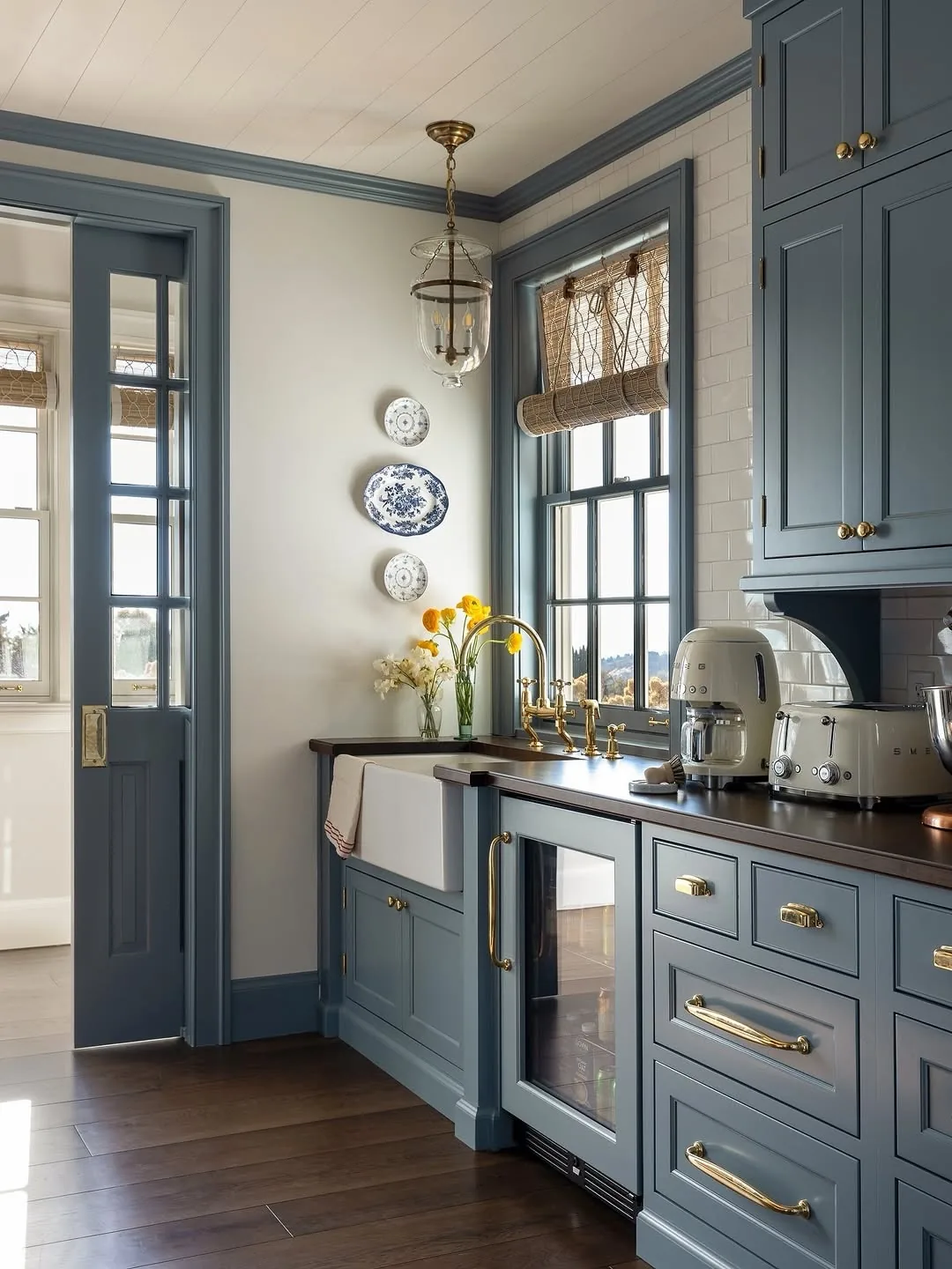 Blue gray farmhouse kitchen with a sink and wood accents
