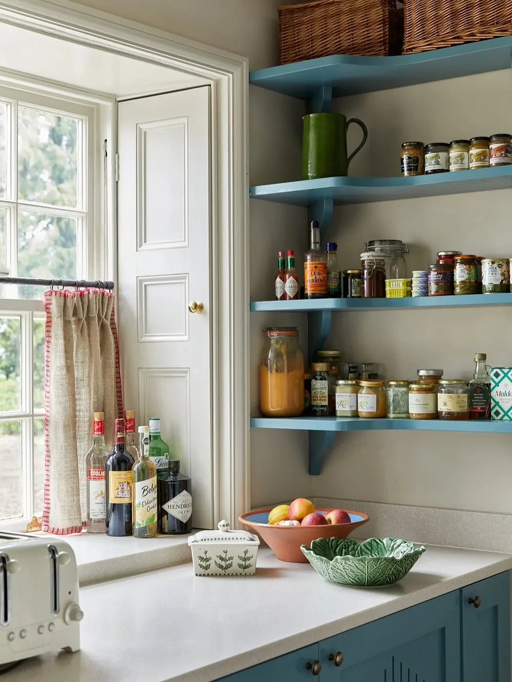Blue open shelving kitchen with a pantry