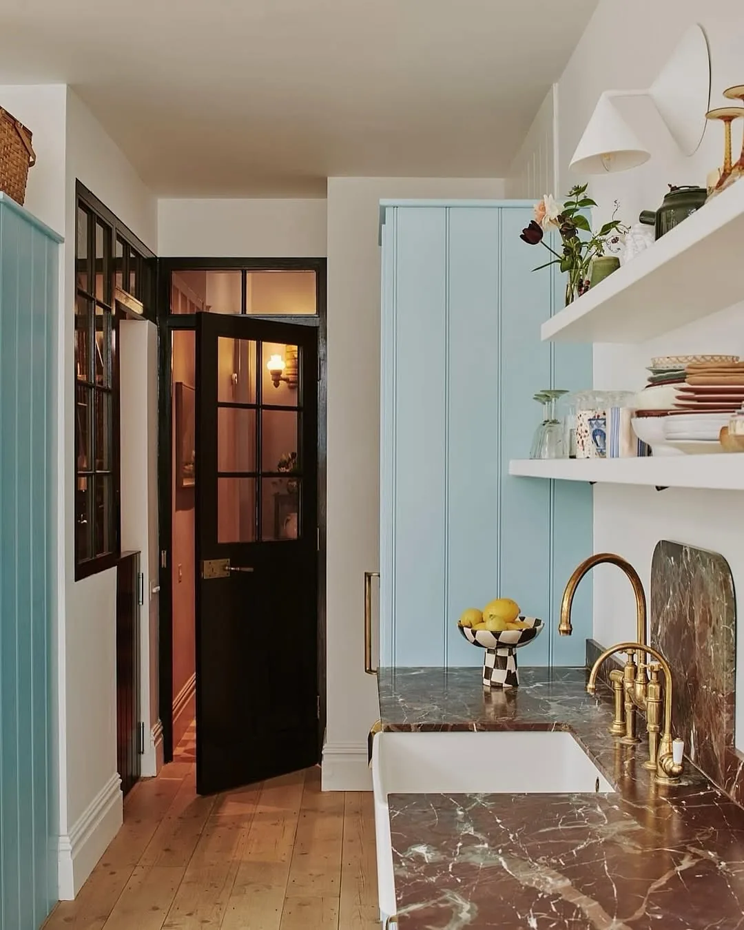 Burgundy marble sink in a blue pantry nook