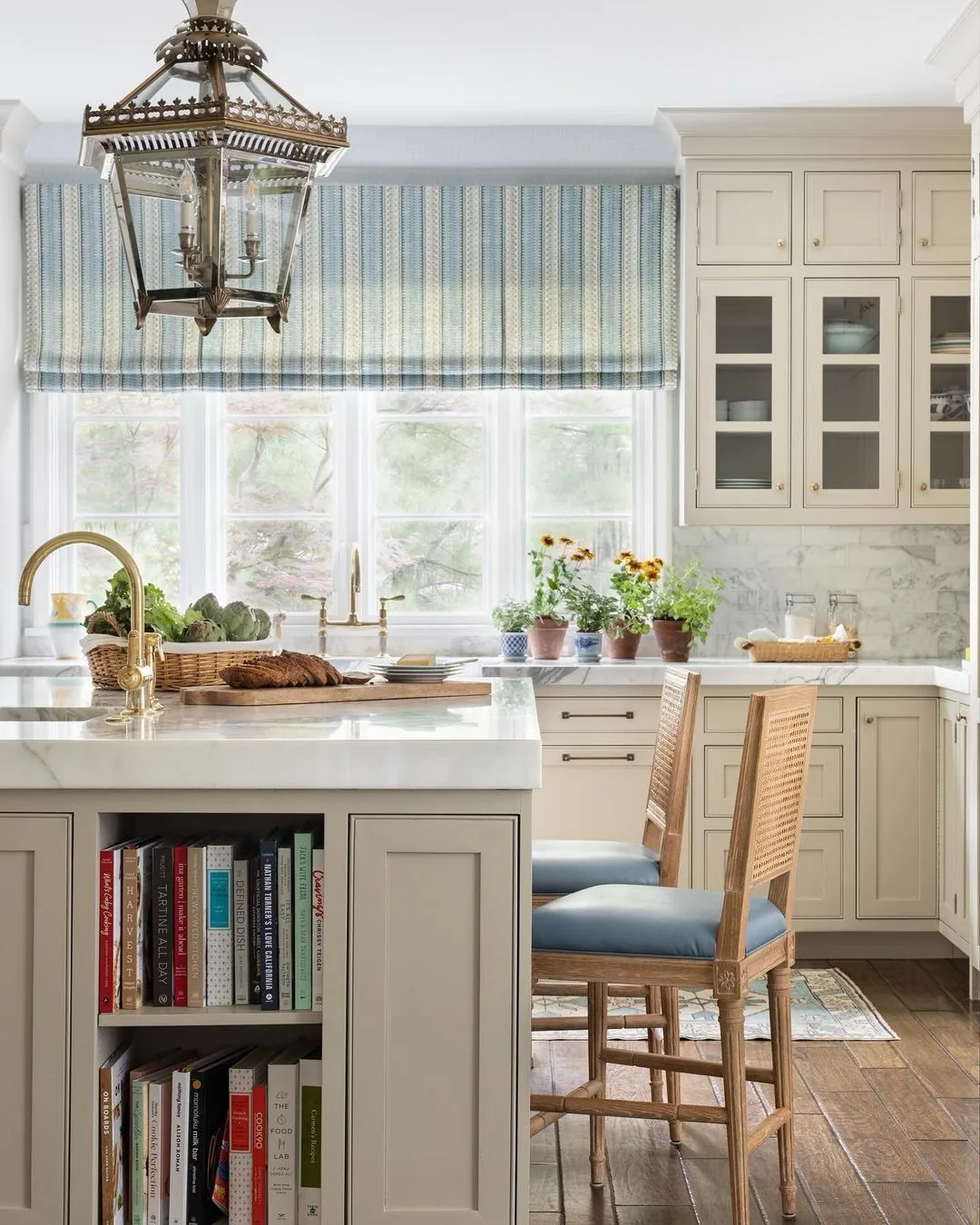 Cream kitchen with a blue striped Roman shade