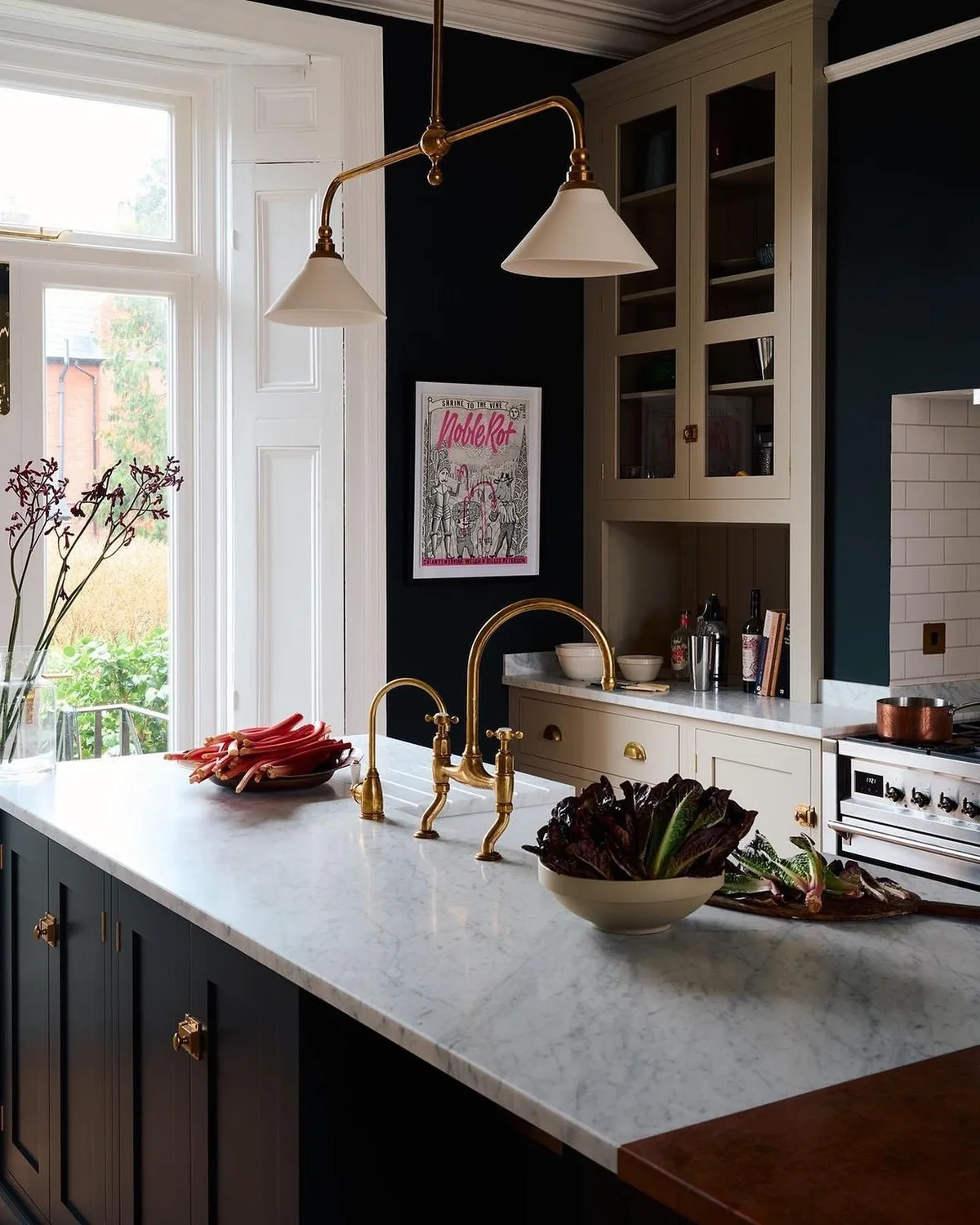 Dark navy kitchen with brass fixtures and pendants