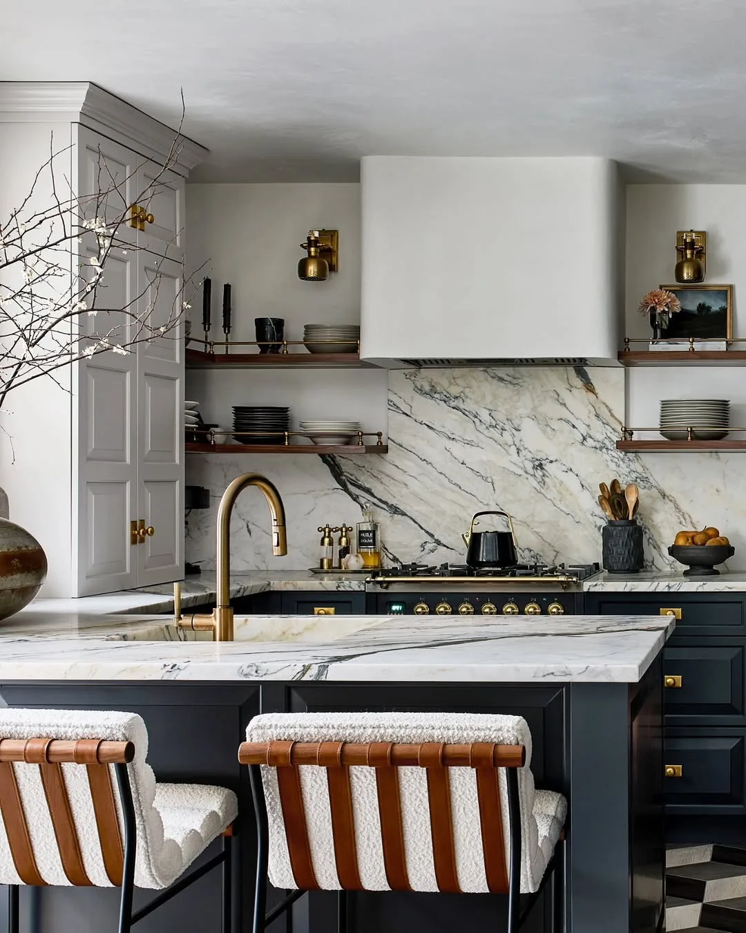 Dark navy kitchen with brass hardware and marble