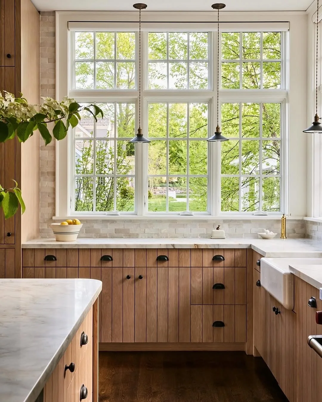 Light wood kitchen cabinets with a window